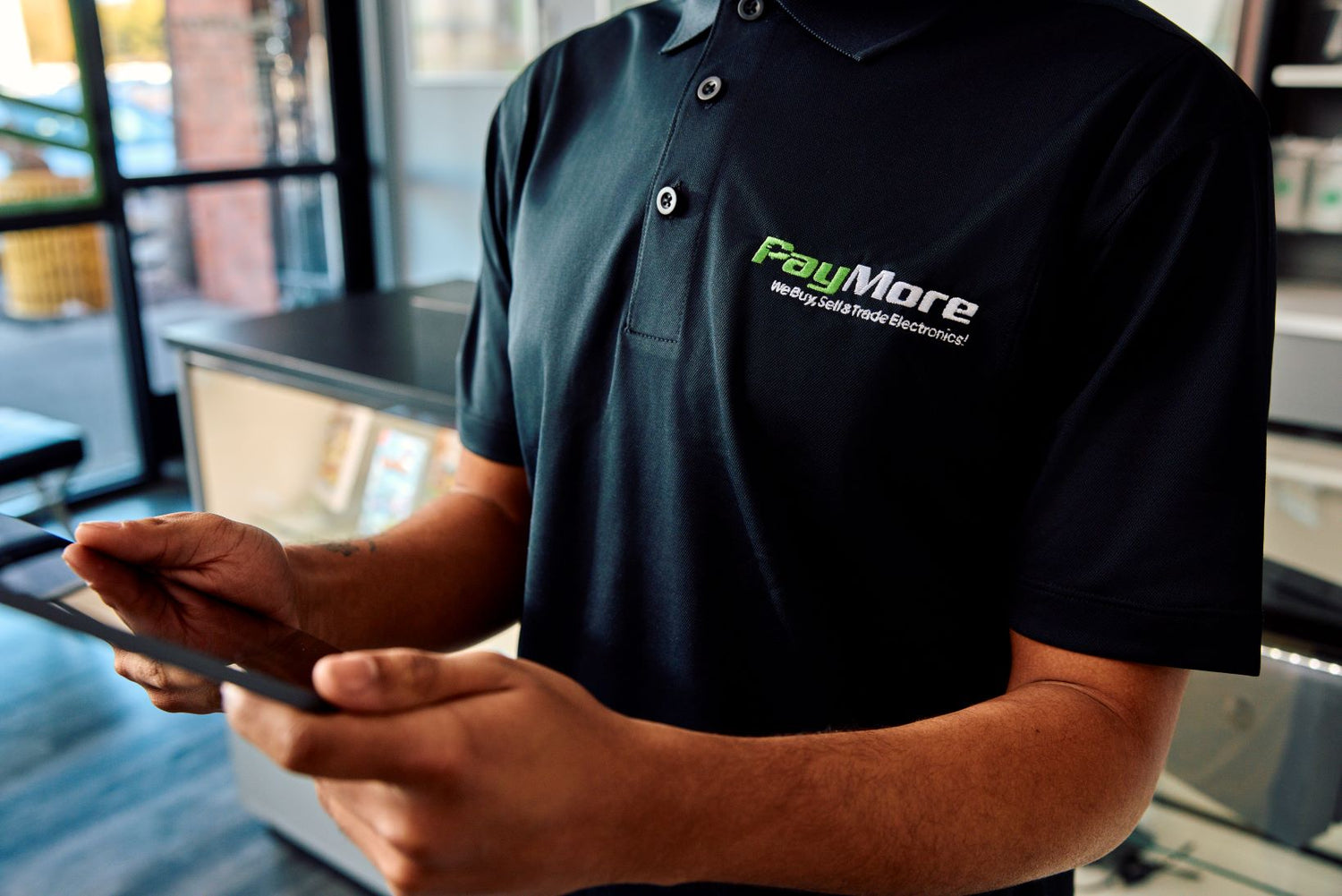 paymore employee holding a tablet